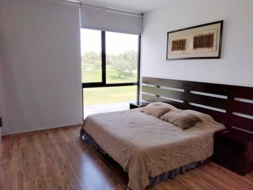 a bedroom with a large bed and a large window at Amazing house with private pool and beautiful view in San Miguel de Allende