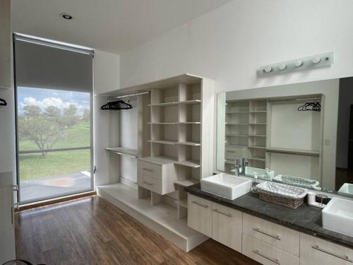 a bathroom with two sinks and a large mirror at Amazing house with private pool and beautiful view in San Miguel de Allende