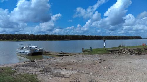 a boat is docked at a dock on a lake at Outback Campground and Marina in Trinity