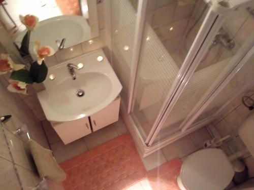 an overhead view of a bathroom with a sink and a shower at Room No3 in Trogir