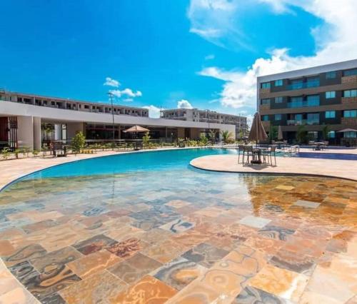 a large swimming pool in front of a building at Beautiful studio Muro Alto mana beach in Ipojuca