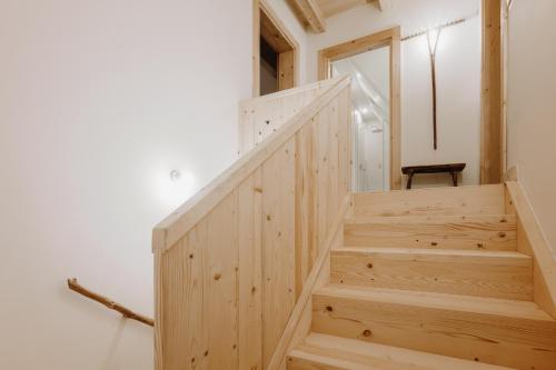 a wooden staircase in a room with a white wall at SOPA Zakopane in Zakopane