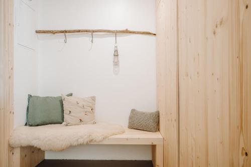 a room with a bench with pillows on it at SOPA Zakopane in Zakopane
