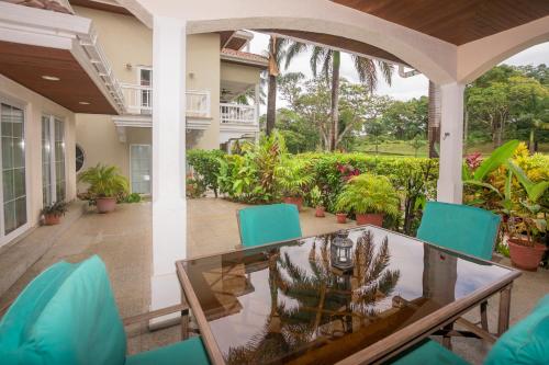 an outdoor patio with a glass table and chairs at Lawson Rock - Yellowfish 110 Condo in Sandy Bay