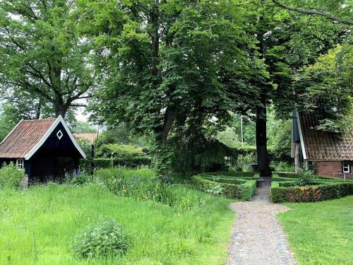 un camino que conduce a un granero y una casa en LooSan Lodges Gastenhuis, en Reutum