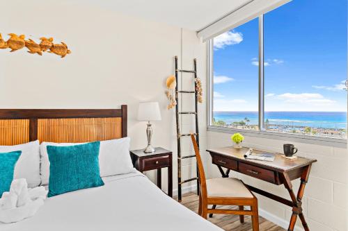 a bedroom with a bed and a desk and a window at Stunning 1BR Ocean View Condo at Ilikai Marina in Honolulu