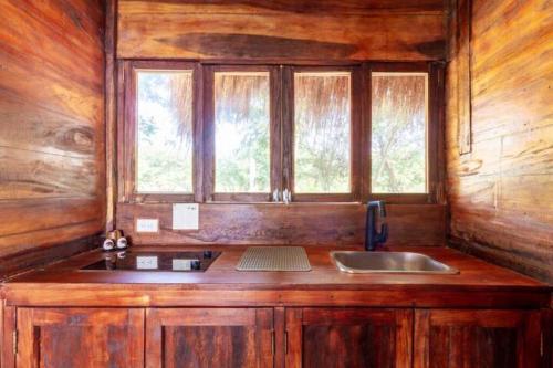 a kitchen with a sink and a window in a cabin at Pamaduih - Suite Above the Sea in Cartagena de Indias