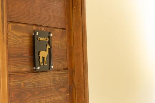 a door with a camel sign on it at Hotel HORSTMEYER in Cochrane