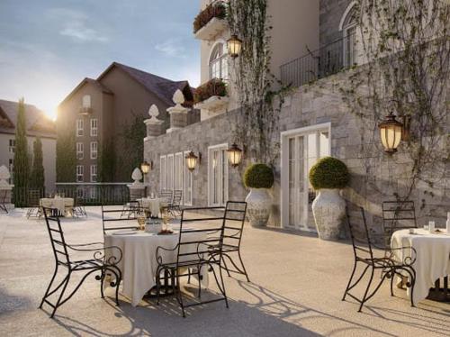 a group of tables and chairs in front of a building at Buona Vitta Resort & Spa in Gramado