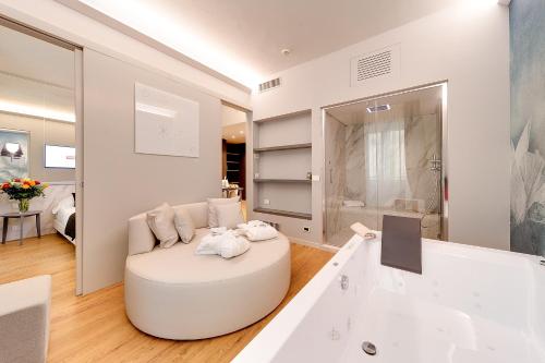a large white bathroom with a tub and a sink at Best Western Hotel Nazionale in Sanremo