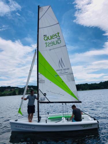 two people on a sail boat on the water at Apartment Relax - Stubenbergsee in Stubenberg