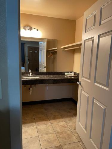 a bathroom with a sink and a large mirror at Fairground Inn in Monroe