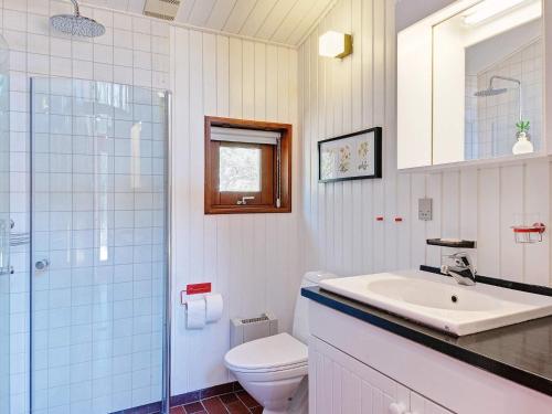a bathroom with a toilet and a sink and a shower at Three-Bedroom Holiday home in Nexø 38 in Vester Sømarken