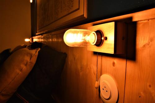 a lightswitch on a wall in a room at Groom Épernay - Le Petit Tonnelier in Épernay