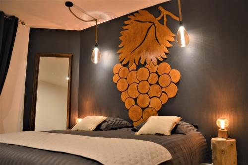 a bedroom with a bed with a bunch of grapes on the wall at Groom Épernay - Le Petit Tonnelier in Épernay