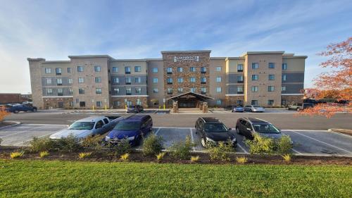 a large building with cars parked in a parking lot at Staybridge Suites Nashville SE - Murfreesboro by IHG in Murfreesboro