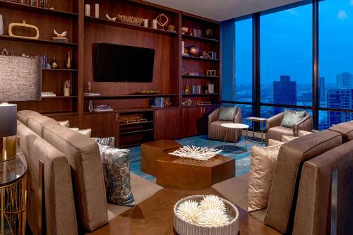 a living room with a couch and a tv at The Westin Galleria Houston in Houston