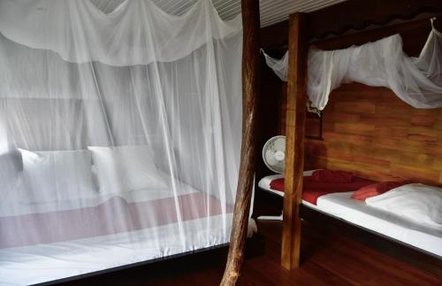 Postel nebo postele na pokoji v ubytování Domaine Karaibes