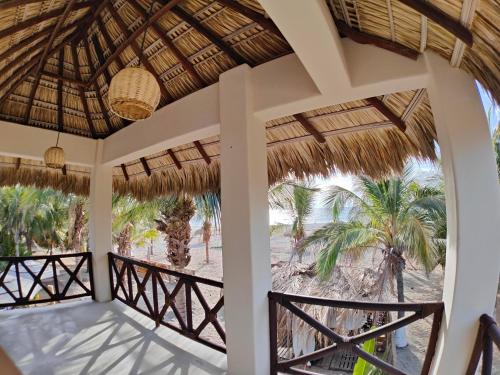 a view from the porch of a resort with palm trees at Casa Kuaa in Brisas de Zicatela
