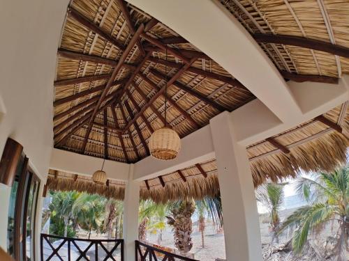 a view from the lobby of a resort with a straw roof at Casa Kuaa in Brisas de Zicatela