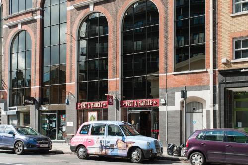 a group of cars parked in front of a building at London Serviced Apartments in London