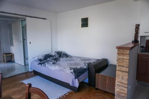 a small bedroom with a bed and a dresser at Studio K2 in Skopje