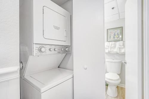 a white laundry room with a washer and dryer at Summer Beach 506 in Ocean City