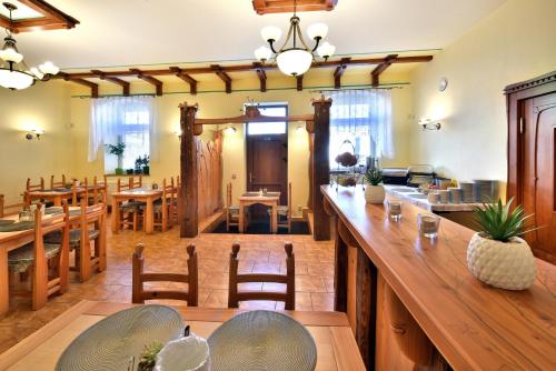 a large dining room with wooden tables and chairs at Penzión Víchrica in Veľká Lomnica