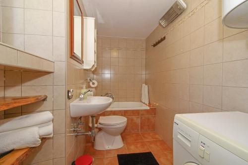 a bathroom with a toilet and a sink and a tub at Marija-Lorena in Gora Glušići (Haus für 4-5 Personen) in Labin