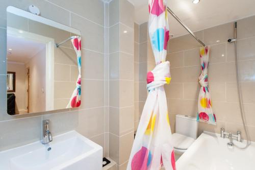 a bathroom with a sink and a mirror at London Serviced Apartments in London