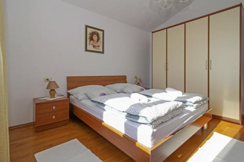 a bedroom with a bed and a dresser at Alena in Debeljuhi (Haus für 4 Personen) in Žminj