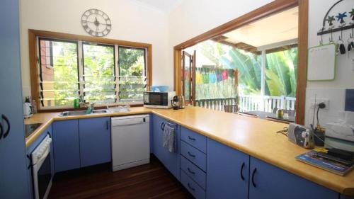 a kitchen with blue cabinets and a clock on the wall at Magnetic Dreams Unit 2 in Arcadia