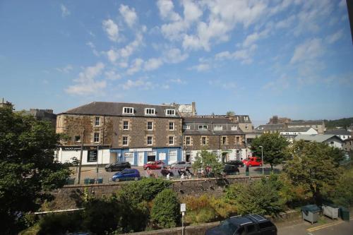 a city with cars parked in a parking lot at Six Stevenson House, Oban in Oban