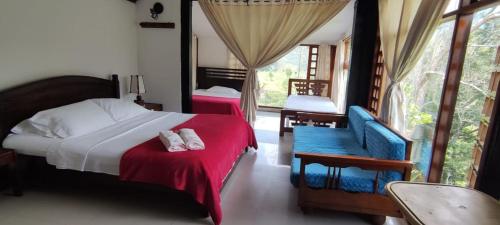 a bedroom with two beds and chairs and a window at Finca Campestre Rancho Alegre in Fusagasuga