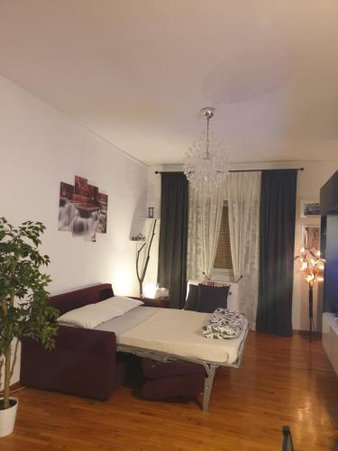 a living room with a bed and a couch at Il Posto Giusto in Ciampino