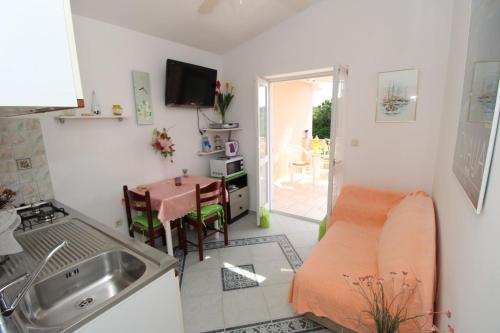 a kitchen with a couch and a table in a room at Apartments for families with children Novalja, Pag - 6490 in Novalja