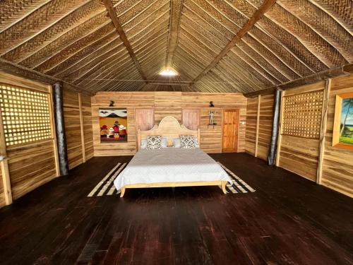 a bedroom with a bed in a wooden room at Hostal velero relax in Santa Marta