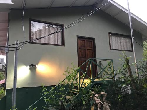 a house with a door and a window at FLOR DE PARAISO BUNGALOWS in Montezuma
