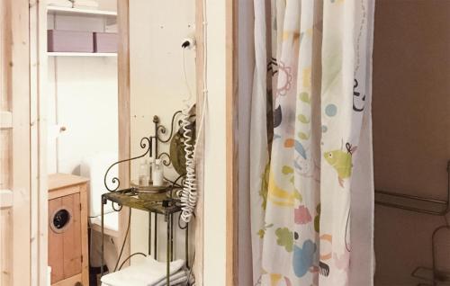 a bathroom with a shower curtain and a toilet at Lovely Home In Kosta With Wifi in Kosta