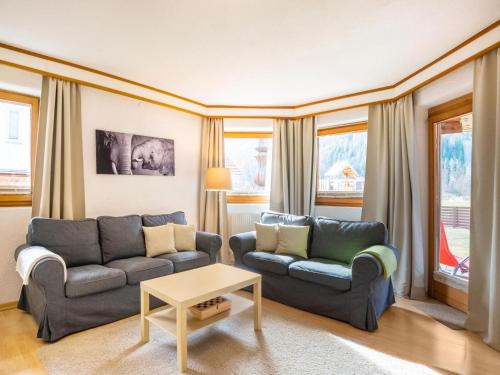 a living room with two couches and a table at Beautiful Apartment in L ngenfeld with Terrace in Längenfeld