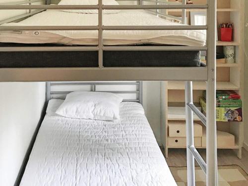 a bedroom with two bunk beds with a white bed at 4 person holiday home in Östhammar-By Traum in Östhammar