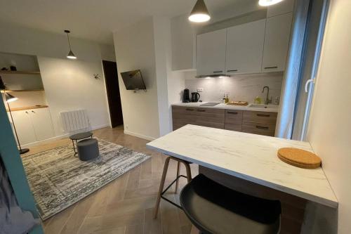a kitchen with a counter and a table in it at Green CityZen Studio Near ParisOrly in Thiais