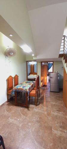 a room with a table and chairs and a kitchen at Sunshine Beach Villa - Kuzhuppilly in Cherai Beach