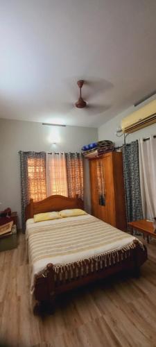 a bedroom with a large bed in a room at Sunshine Beach Villa - Kuzhuppilly in Cherai Beach
