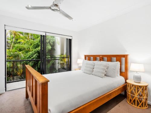 a bedroom with a bed and a large window at Luxury Stunning Nobby's Beach Home 2bd + Den ! in Gold Coast