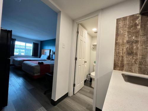 a hotel room with a bed and a bathroom at Town Place Studio in Snyder