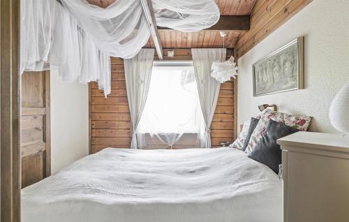 a bedroom with a white bed and a window at Stunning Home In Västra Torup With Wifi in Västra Torup