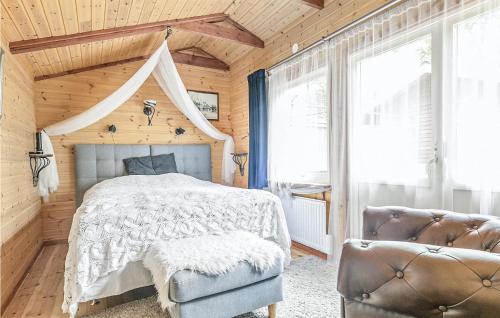 a bedroom with a bed and a wooden ceiling at Stunning Home In Västra Torup With Wifi in Västra Torup