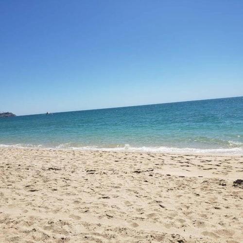a sandy beach with the ocean in the background at LUX 3 MASTER BDROOM ON SANDY BEACH w NO CLEAINING FEE in Puerto Peñasco