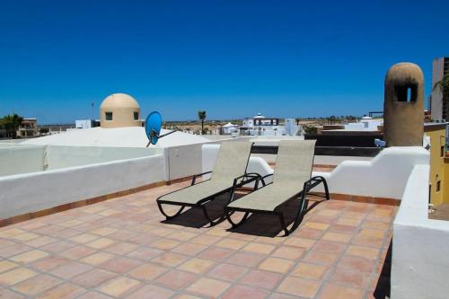 two benches sitting on top of a roof at LUX 3 MASTER BDROOM ON SANDY BEACH w NO CLEAINING FEE in Puerto Peñasco